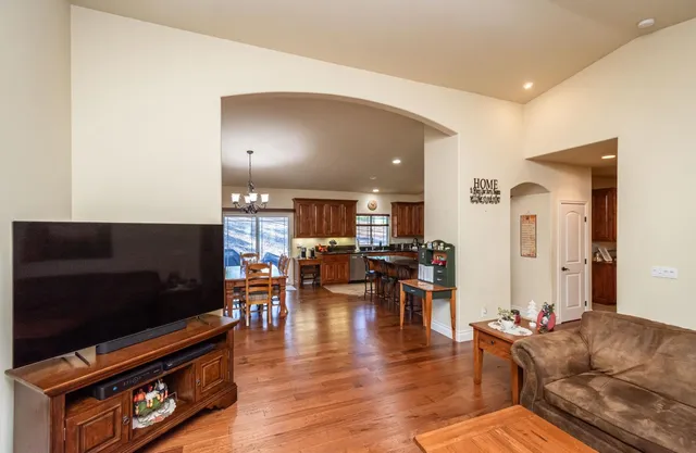 a very nice looking dining room with kitchen island furniture and a chandelier