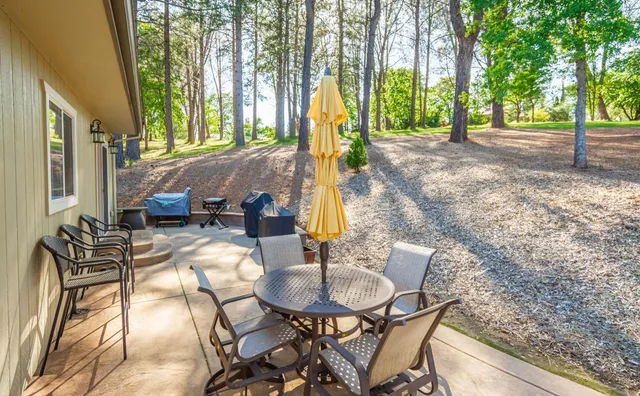 an aerial view of residential houses with outdoor space and trees all around