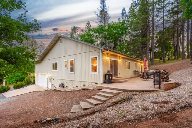 a backyard of a house with plants and trees