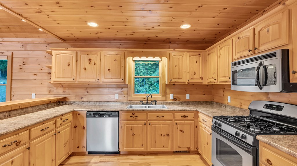 691 Mitchell Branch Road Morganton, GA 30560 - Photo 17 of 77 a kitchen with stainless steel appliances granite countertop a stove sink and cabinets