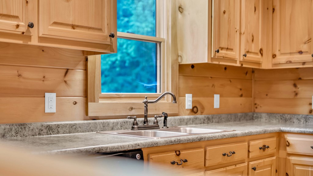 691 Mitchell Branch Road Morganton, GA 30560 - Photo 18 of 77 a bathroom with a granite countertop sink and a mirror