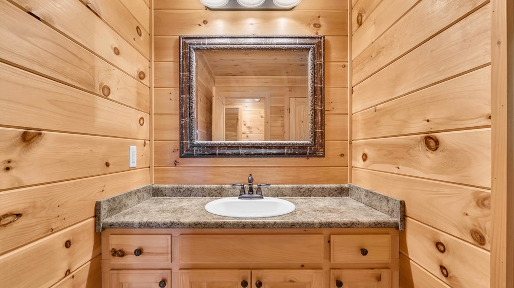 691 Mitchell Branch Road Morganton, GA 30560 - Photo 25 of 77 a bathroom with a granite countertop sink and a mirror