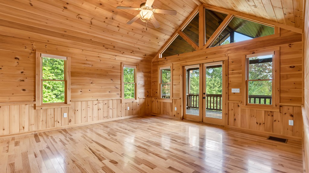 691 Mitchell Branch Road Morganton, GA 30560 - Photo 35 of 77 a view of an empty room with wooden floor and a window