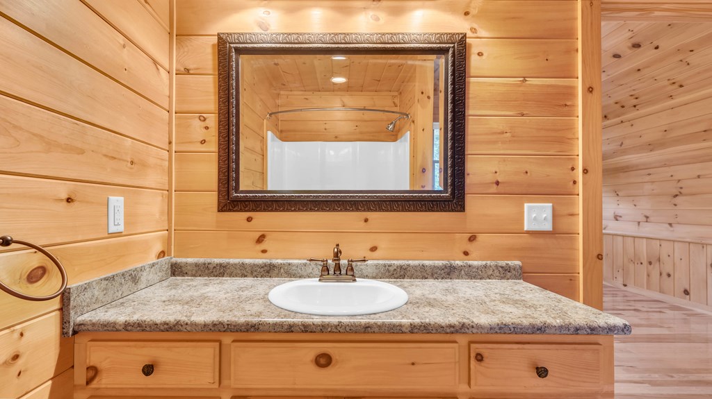 691 Mitchell Branch Road Morganton, GA 30560 - Photo 44 of 77 a bathroom with a granite countertop sink and a mirror