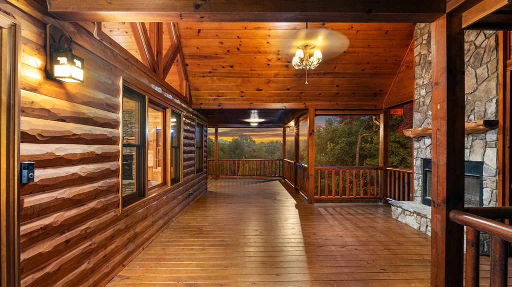 691 Mitchell Branch Road Morganton, GA 30560 - Photo 60 of 77 a view of a porch with wooden floor and floor to ceiling window