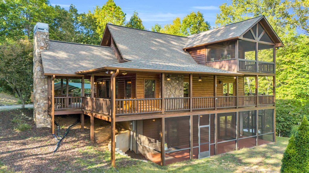 691 Mitchell Branch Road Morganton, GA 30560 - Photo 61 of 77 a view of house with large windows and a yard