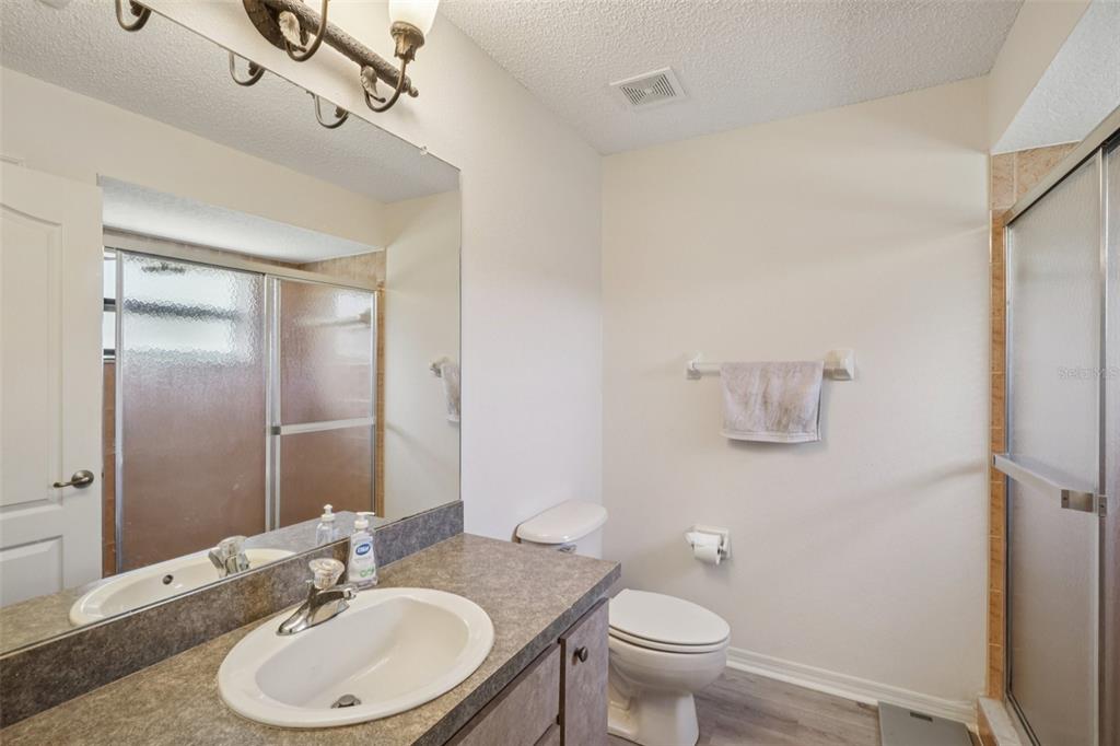 8340 Nevada Street Spring Hill, FL 34606 - Photo 13 of 23 a bathroom with a sink toilet and mirror