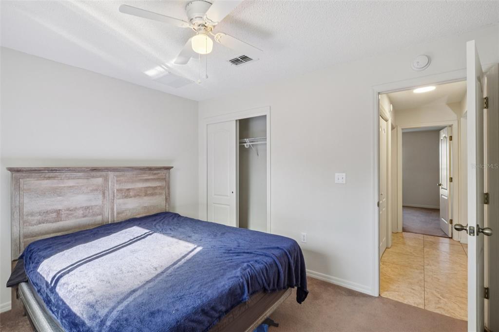 8340 Nevada Street Spring Hill, FL 34606 - Photo 15 of 23 a bedroom with a bed and a chandelier