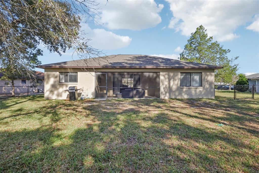 8340 Nevada Street Spring Hill, FL 34606 - Photo 20 of 23 a front view of a house with a garden