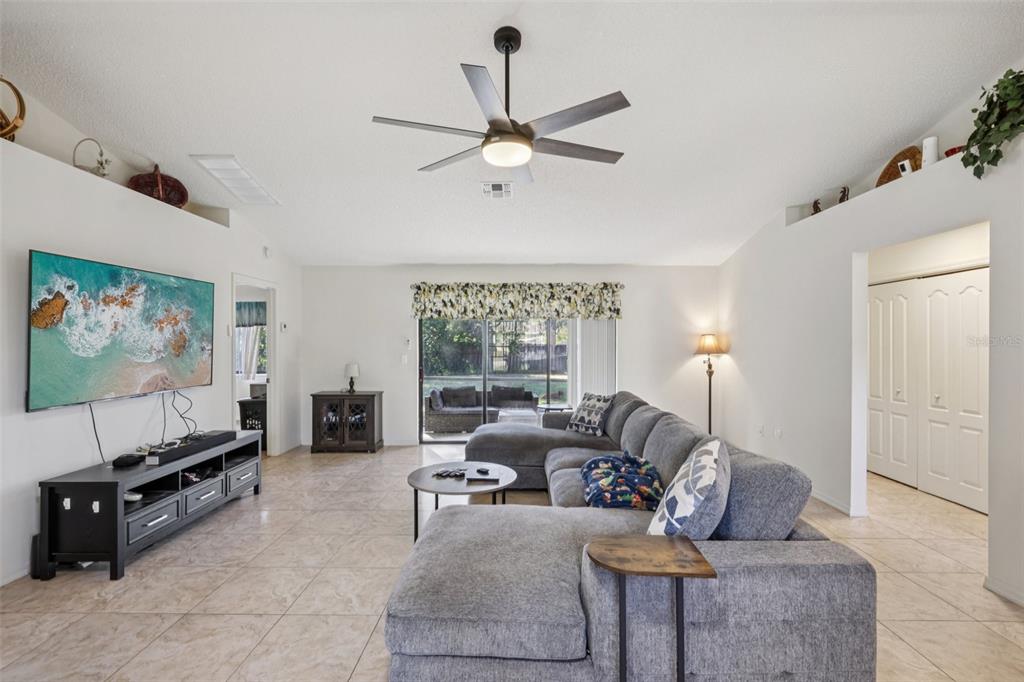 8340 Nevada Street Spring Hill, FL 34606 - Photo 4 of 23 a living room with furniture and a flat screen tv