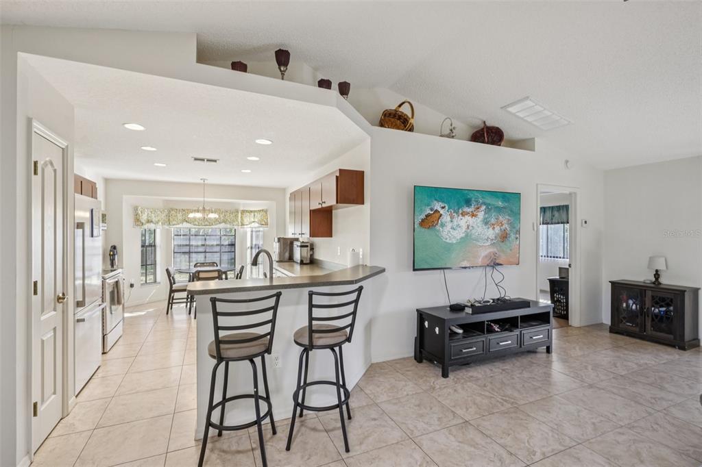 8340 Nevada Street Spring Hill, FL 34606 - Photo 6 of 23 a living room with furniture and a flat screen tv