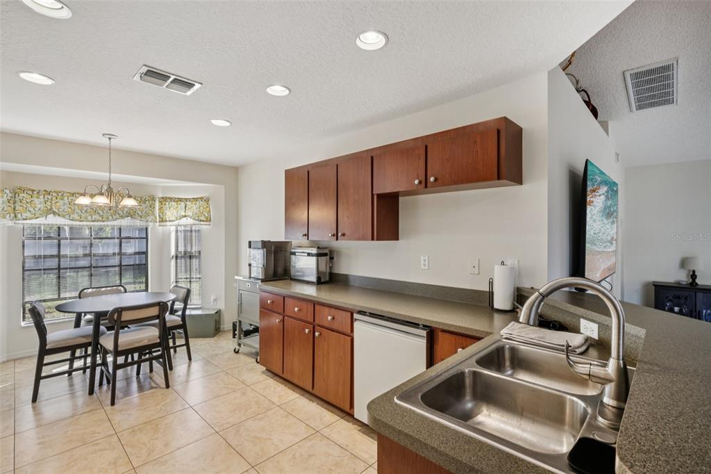 8340 Nevada Street Spring Hill, FL 34606 - Photo 7 of 23 a kitchen that has a sink cabinets and appliances