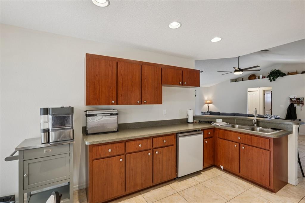 8340 Nevada Street Spring Hill, FL 34606 - Photo 10 of 23 a kitchen with a sink a stove and cabinets