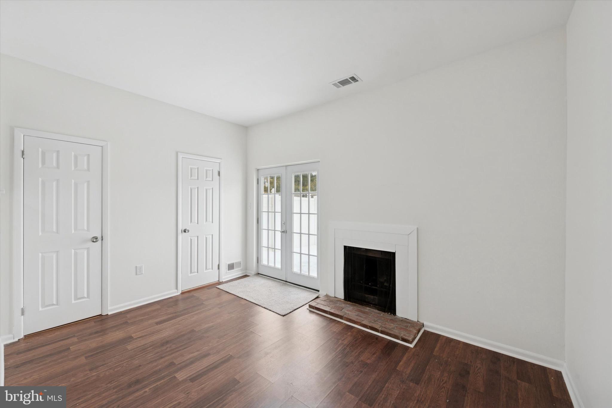 21 Markel Road Malvern, PA 19355 - Photo 10 of 23 an empty room with wooden floor and fireplace