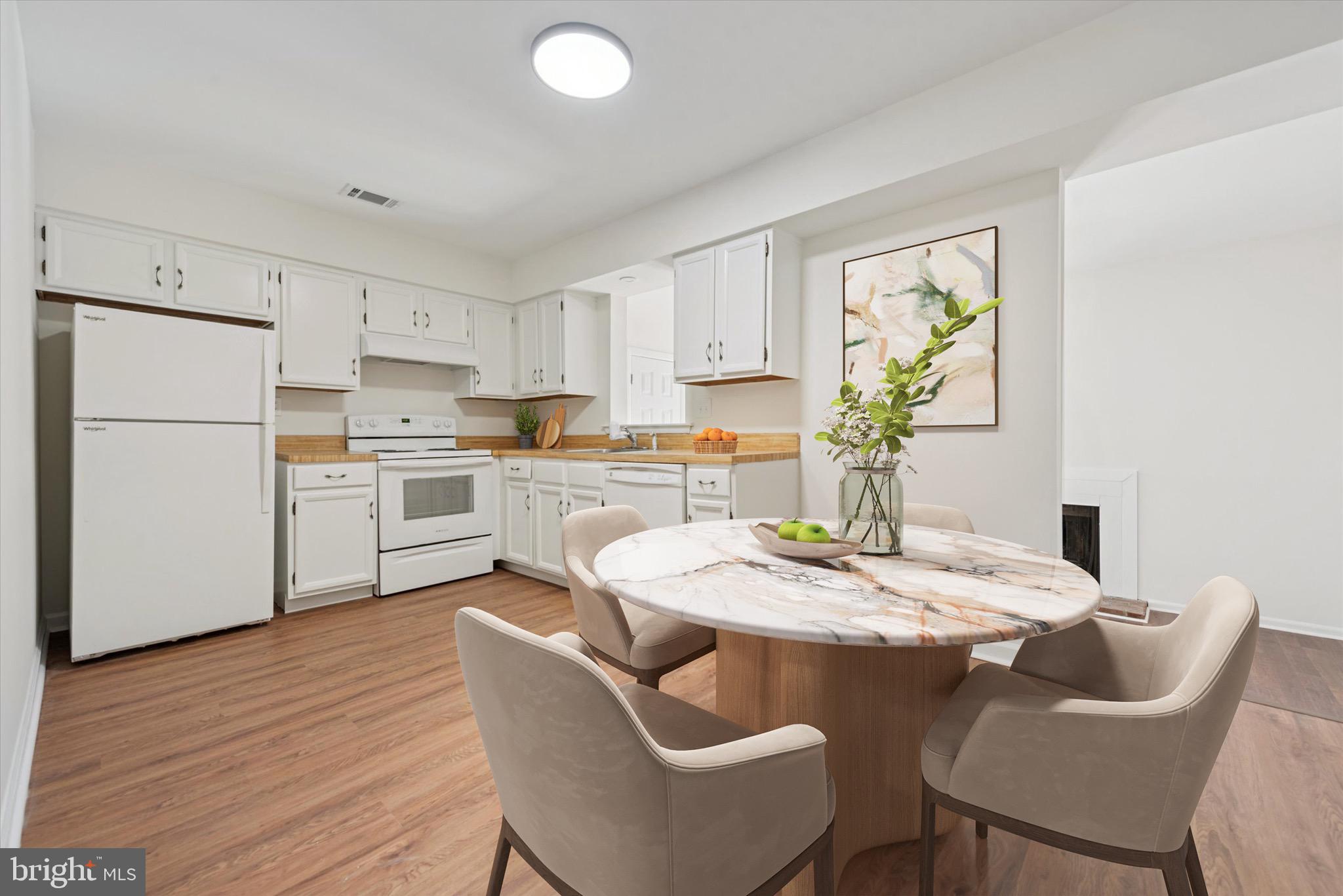21 Markel Road Malvern, PA 19355 - Photo 7 of 23 a kitchen with stainless steel appliances kitchen island granite countertop a dining table chairs and white cabinets