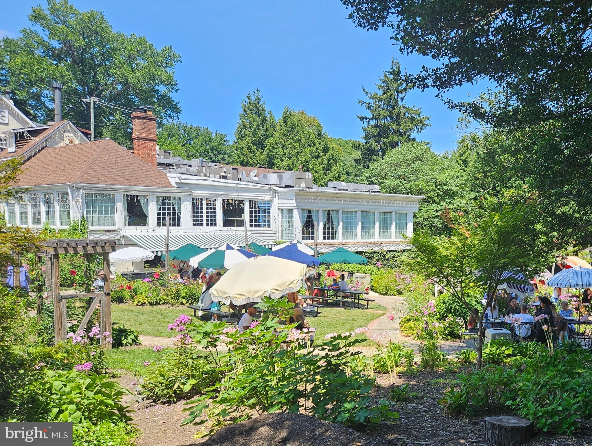 302 Ellsworth Drive Silver Spring, MD 20910 - Photo 62 of 64 a front view of a house with a yard and fountain
