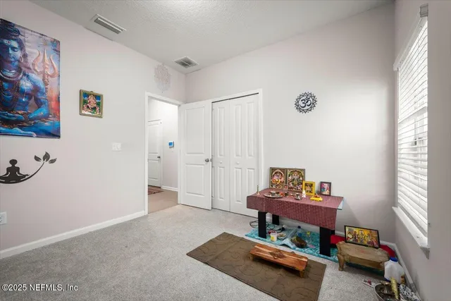 a living room with furniture fireplace and a large window
