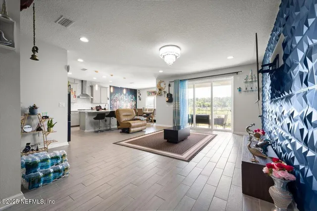 a living room with furniture and a chandelier