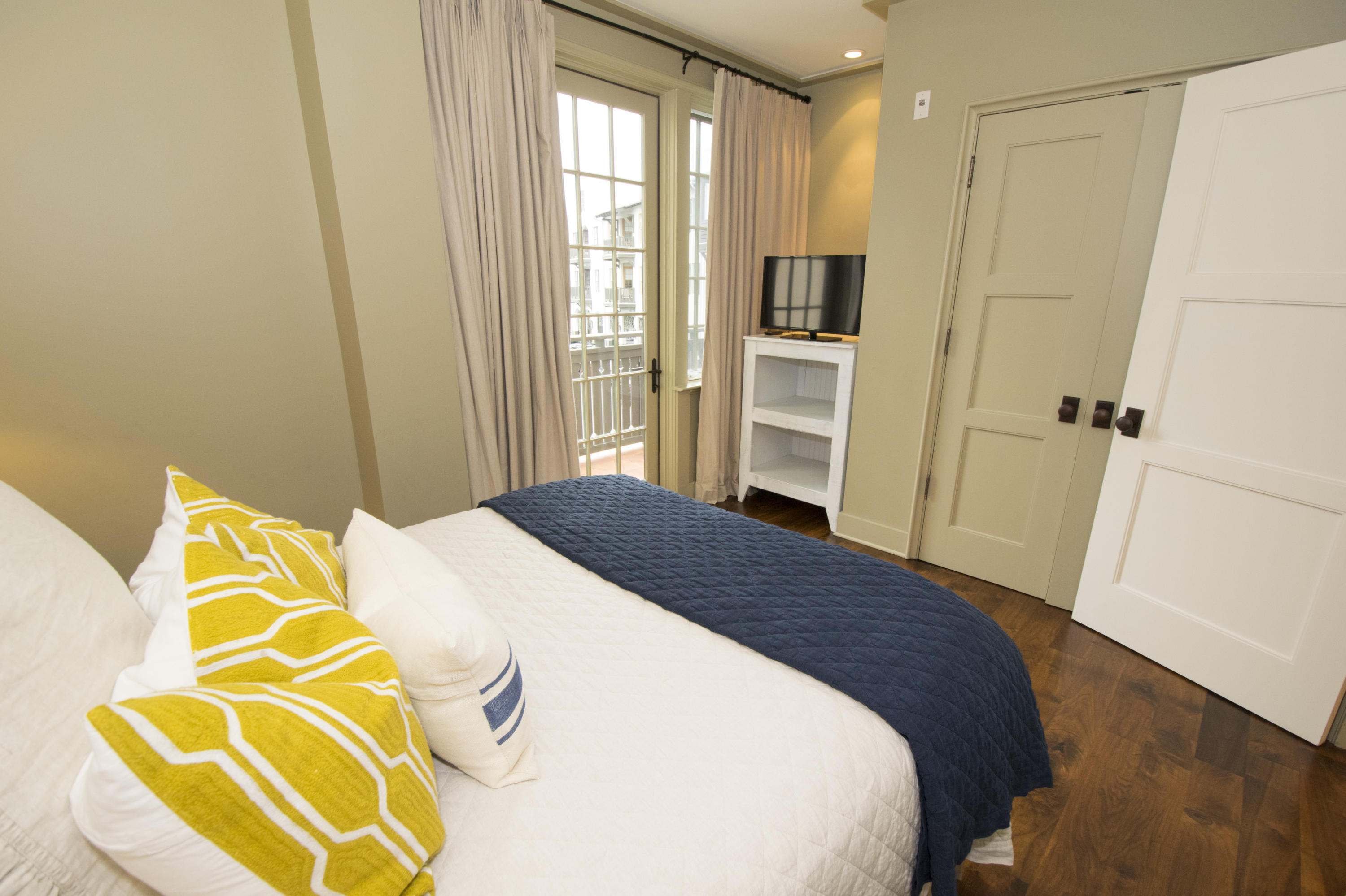 78 North Barrett Square, Unit 2 Rosemary Beach, FL 32461 - Photo 12 of 27 a bedroom with a bed and wooden floor