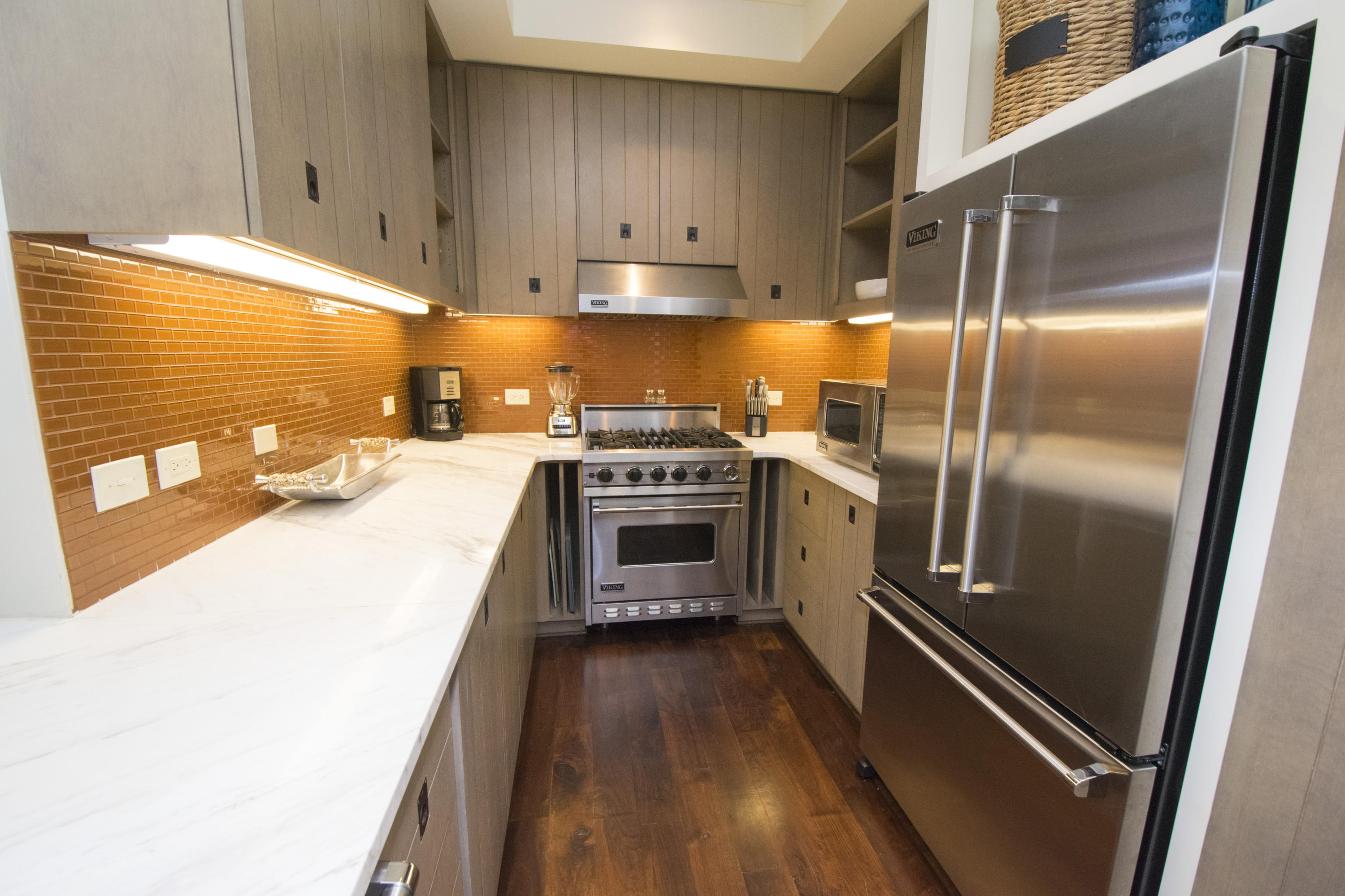 78 North Barrett Square, Unit 2 Rosemary Beach, FL 32461 - Photo 8 of 27 a kitchen with granite countertop stainless steel appliances and wooden cabinets