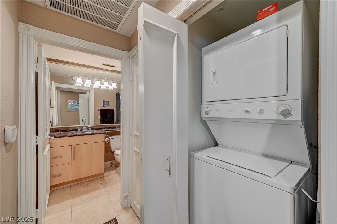 230 East Flamingo Road, Unit 333 Las Vegas, NV 89169 - Photo 33 of 61 An efficient laundry closet opens directly off the tiled hallway leading to the bathroom.