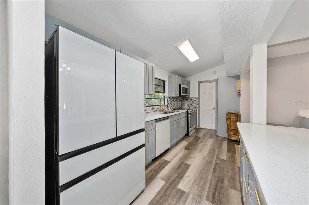 357 Ridgewood Street Altamonte Springs, FL 32701 - Photo 9 of 36 a kitchen with cabinets and wooden floor