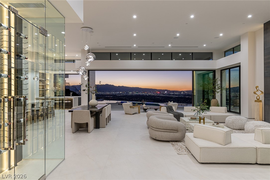 563 Grand Rim Drive Henderson, NV 89012 - Photo 43 of 70 Gaze upon city lights and mountain vistas from this spacious, open-concept living area with a sleek wine cellar.