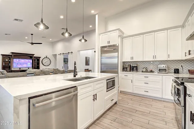 a bathroom with a granite countertop sink mirror and shower