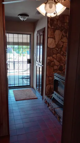 a room with a large window and chandelier