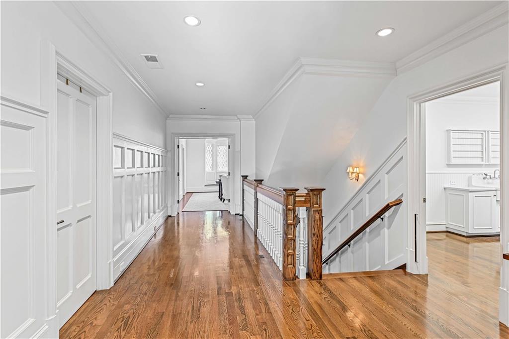 369 Pine Tree Drive Northeast Atlanta, GA 30305 - Photo 31 of 103 a view of a hallway with wooden floor and staircase