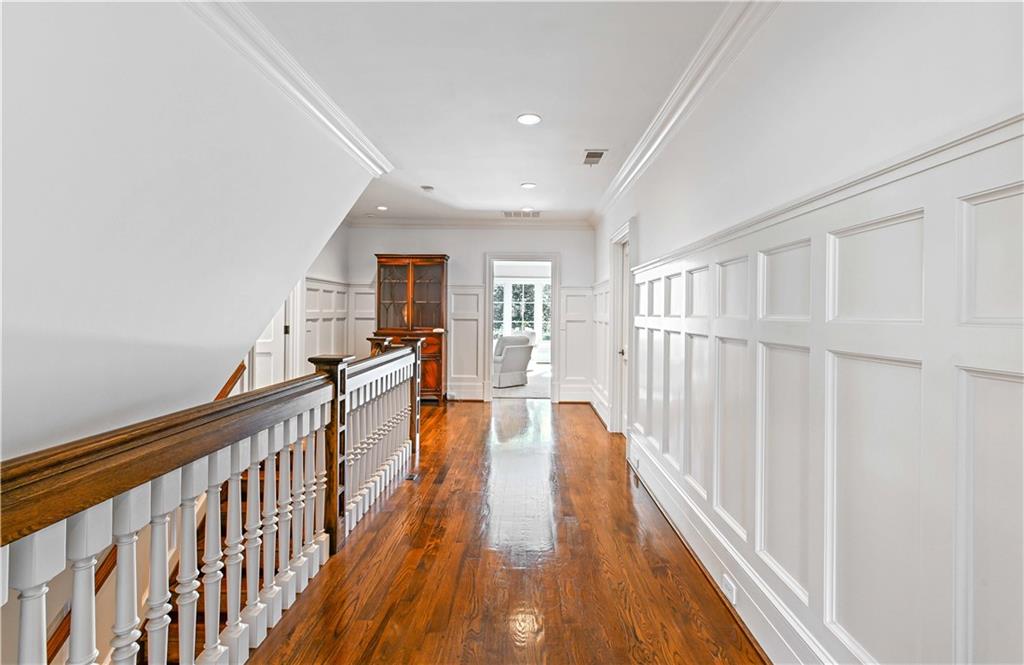369 Pine Tree Drive Northeast Atlanta, GA 30305 - Photo 32 of 103 a view of a hallway with wooden floor and staircase