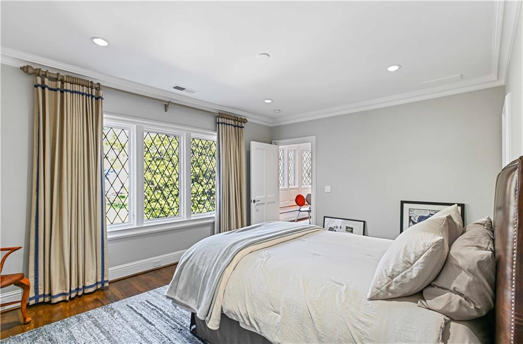369 Pine Tree Drive Northeast Atlanta, GA 30305 - Photo 51 of 103 a bed sitting in a bedroom next to a window
