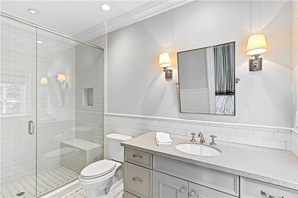 369 Pine Tree Drive Northeast Atlanta, GA 30305 - Photo 53 of 103 a bathroom with a granite countertop sink toilet and shower