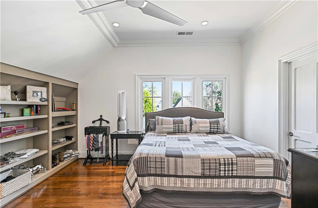 369 Pine Tree Drive Northeast Atlanta, GA 30305 - Photo 66 of 103 a bedroom with a bed a dresser and book shelf