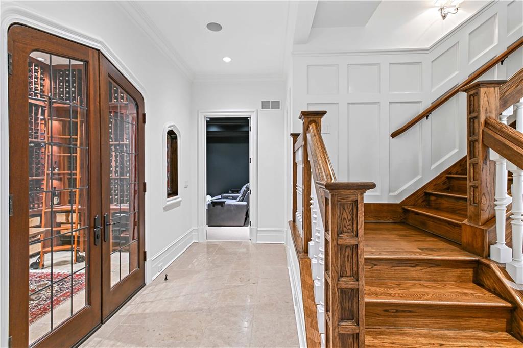 369 Pine Tree Drive Northeast Atlanta, GA 30305 - Photo 68 of 103 a view of a hallway with wooden floor and staircase