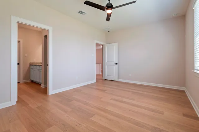 a bathroom with a granite countertop sink a toilet and shower