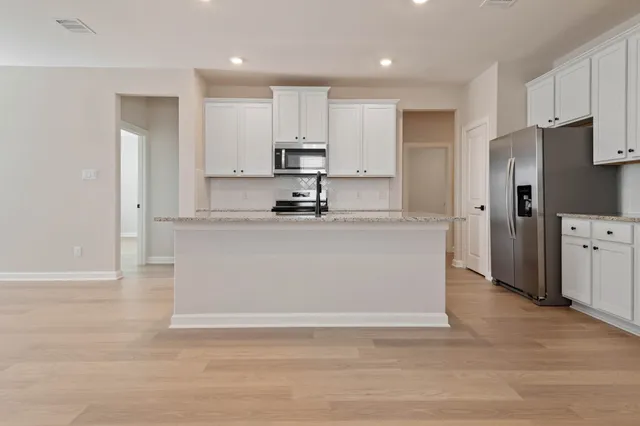 a kitchen with sink and cabinets