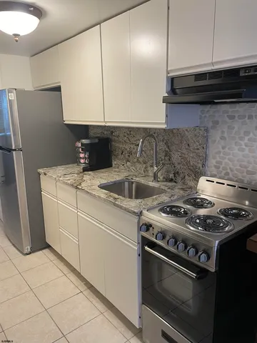 a white stove top oven sitting inside of a kitchen