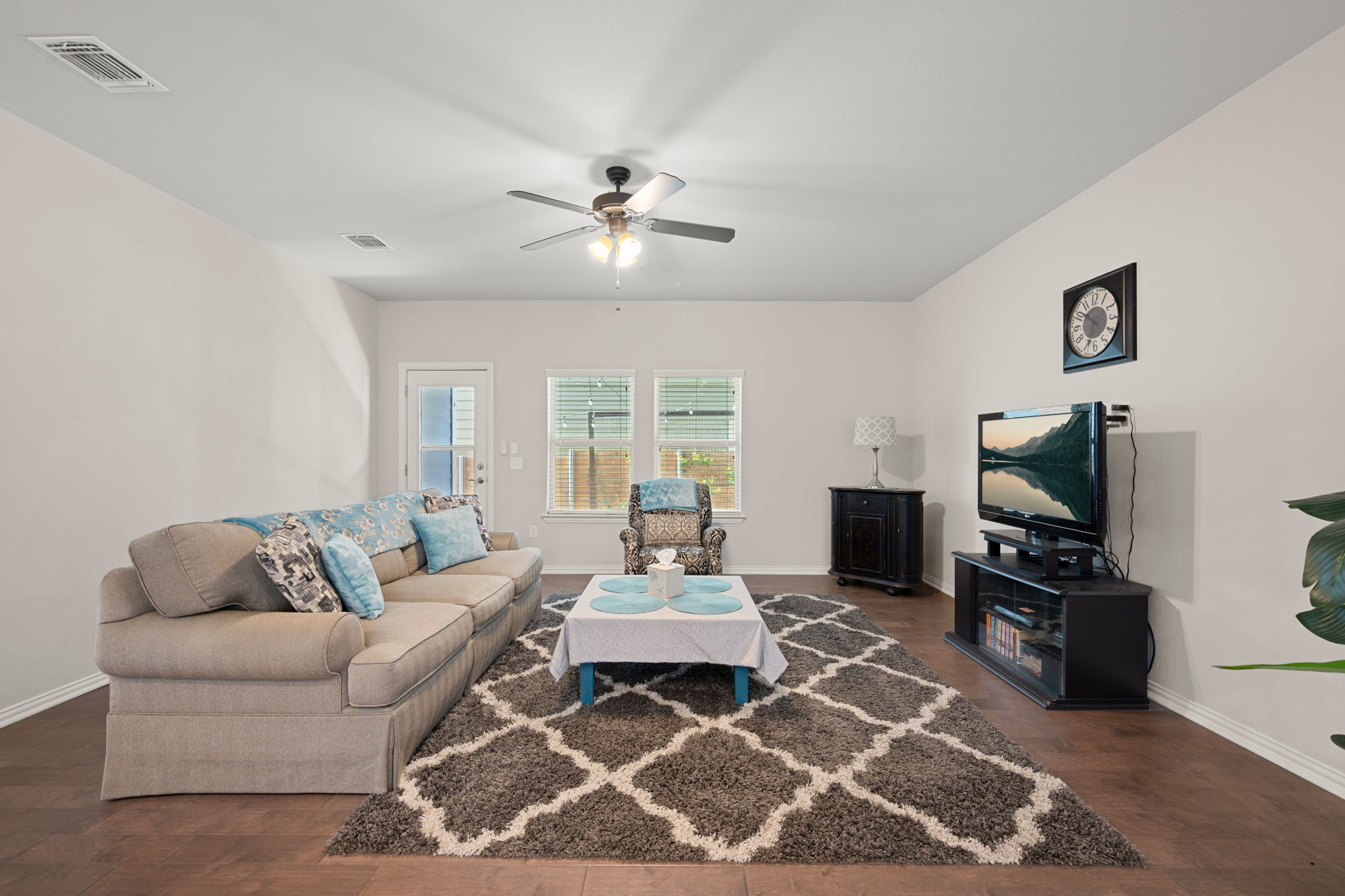 8800 Slater Drive Austin, TX 78747 - Photo 14 of 40 a living room with furniture a flat screen tv and a chandelier