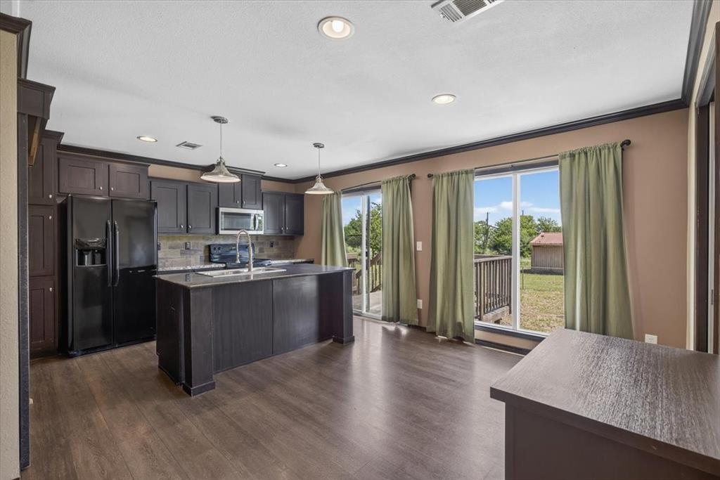 1129 Ragsdale Street Terrell, TX 75160 - Photo 5 of 29 Kitchen with granite counter tops, stainless style appliance and a breakfast bar.