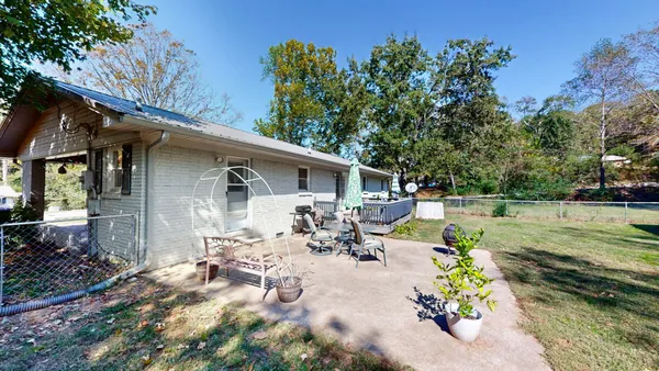 a view of a house with swimming pool and sitting area