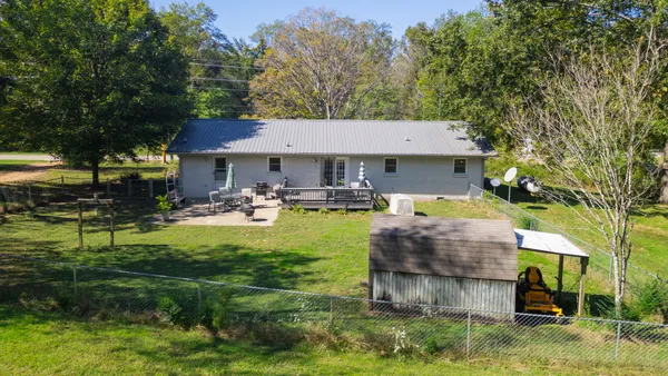 a view of a house with backyard and sitting area