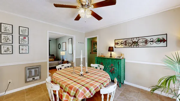 a bedroom with a bed table and a flat screen tv
