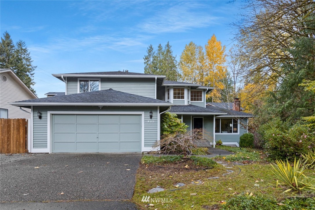 915 215th Street Southeast Bothell, WA 98021 - Photo 2 of 33 a front view of a house with a yard and garage