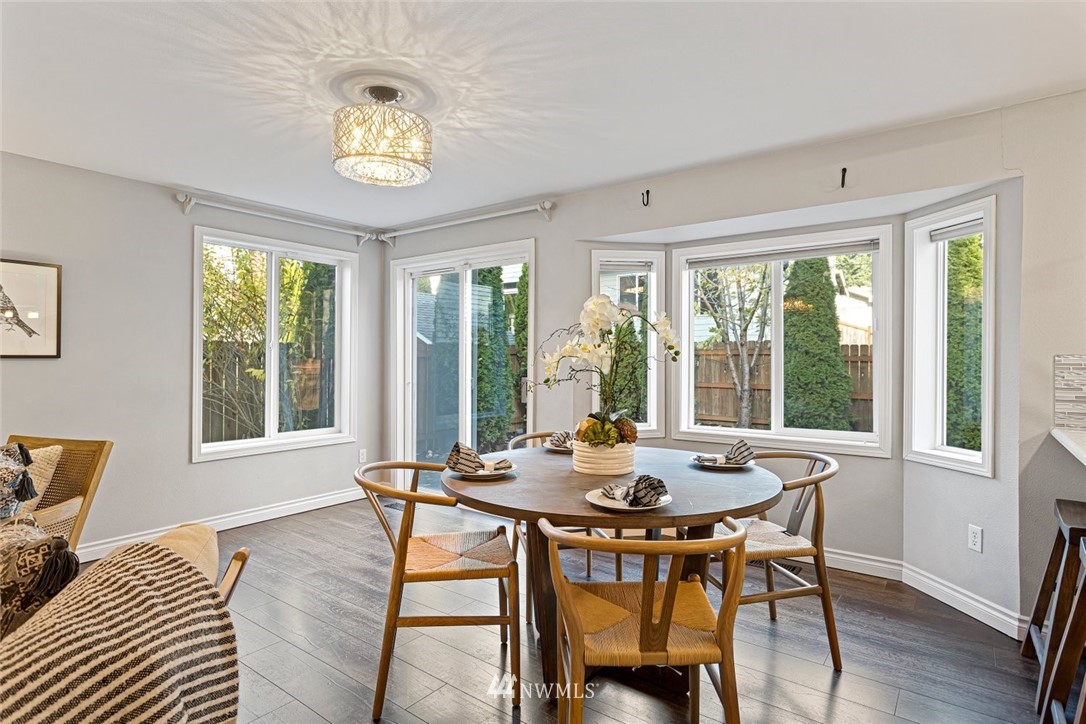 915 215th Street Southeast Bothell, WA 98021 - Photo 15 of 33 a view of a dining room with furniture a chandelier and wooden floor