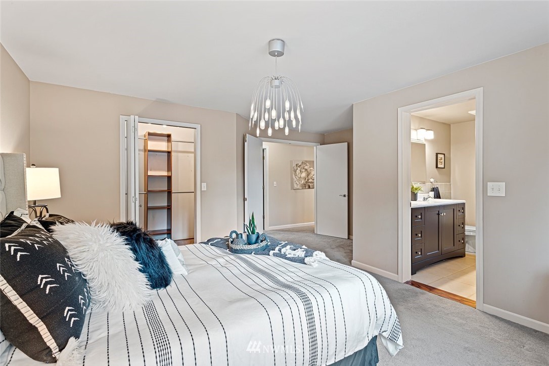 915 215th Street Southeast Bothell, WA 98021 - Photo 20 of 33 a bedroom with a bed and a chandelier