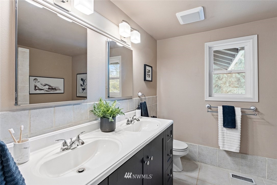 915 215th Street Southeast Bothell, WA 98021 - Photo 22 of 33 a bathroom with a sink a toilet and mirror