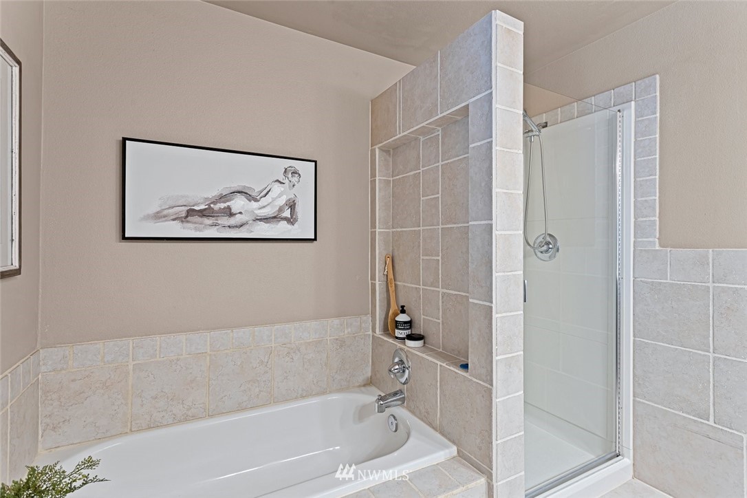 915 215th Street Southeast Bothell, WA 98021 - Photo 23 of 33 a bathroom with a bathtub and a shower