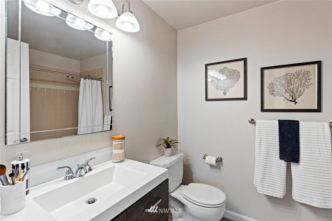 915 215th Street Southeast Bothell, WA 98021 - Photo 27 of 33 a bathroom with a toilet a sink and mirror