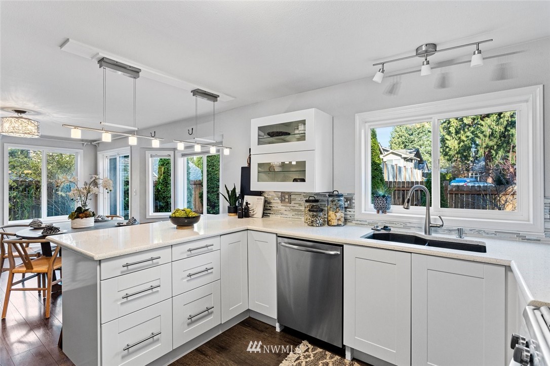 915 215th Street Southeast Bothell, WA 98021 - Photo 5 of 33 a open kitchen with white cabinets and white appliances